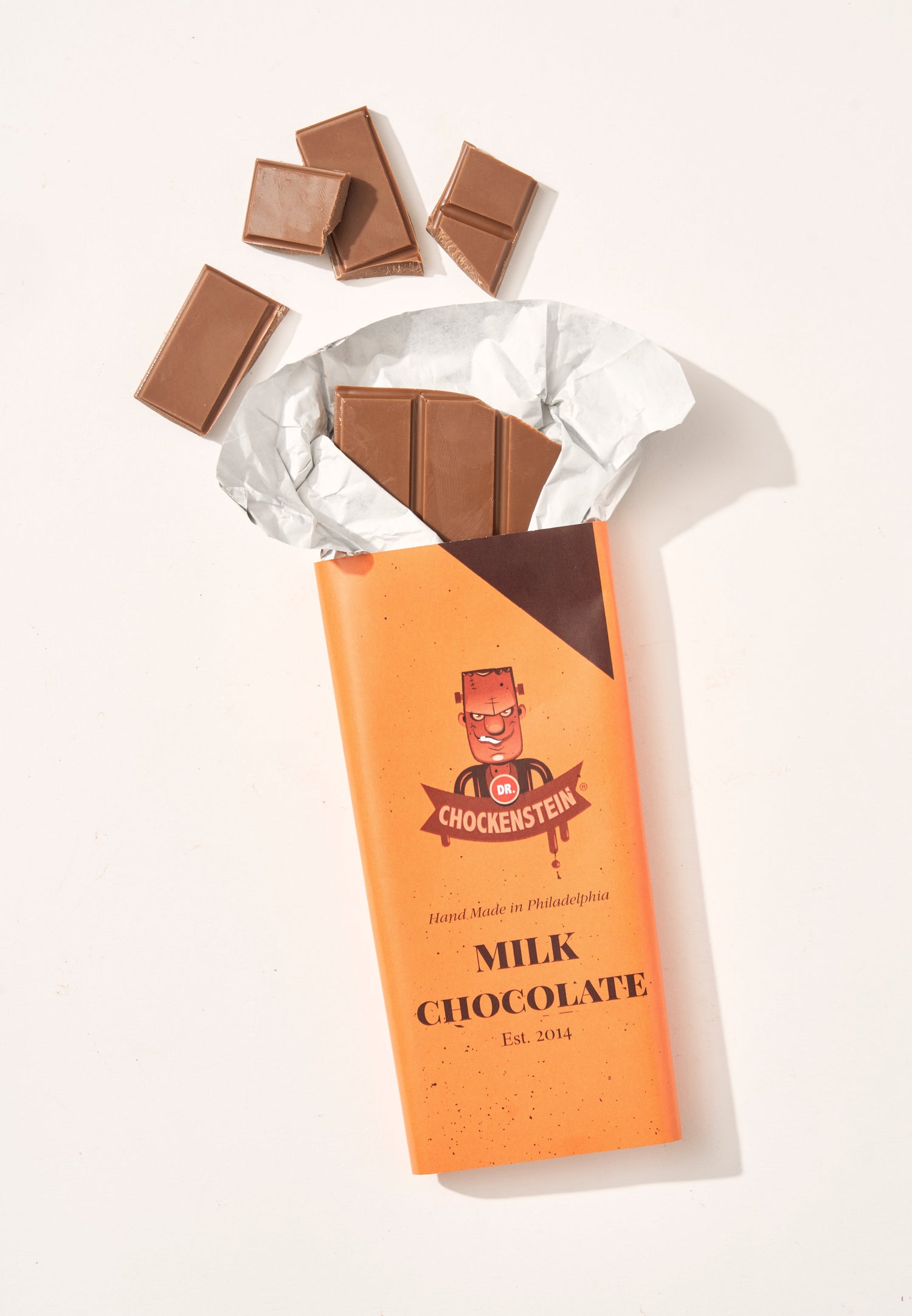 Dr.Chockenstein milk chocolate bar opened with pieces broken