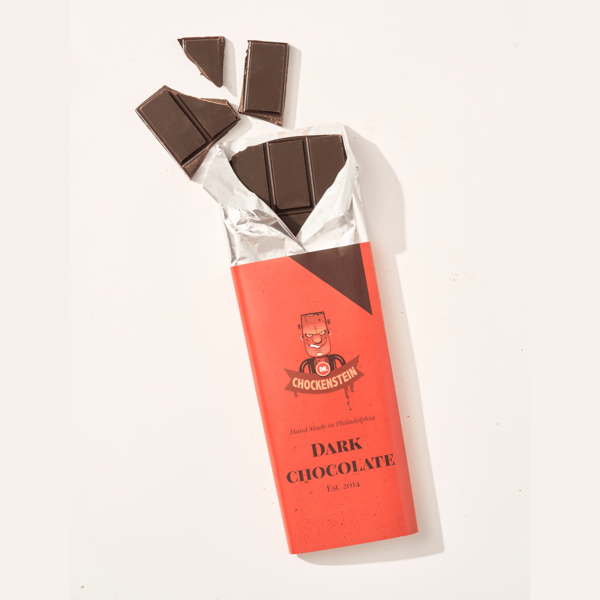 Dr Chockenstein Dark chocolate bar, opened to show the chocolate.